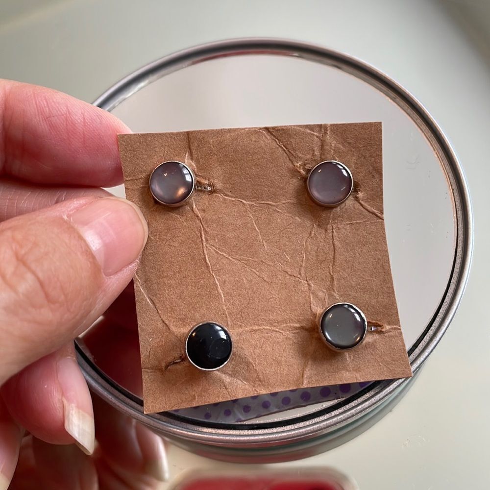Three silver & iridescent gray + one black round tuxedo shirt studs